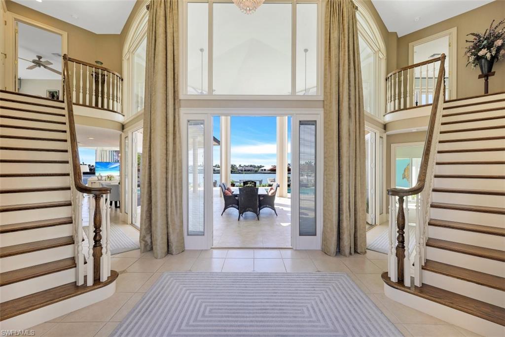 856 Inlet Drive Marco Island, FL 34145 - Photo 19 of 35 a view of a hallway with wooden floor and dining room