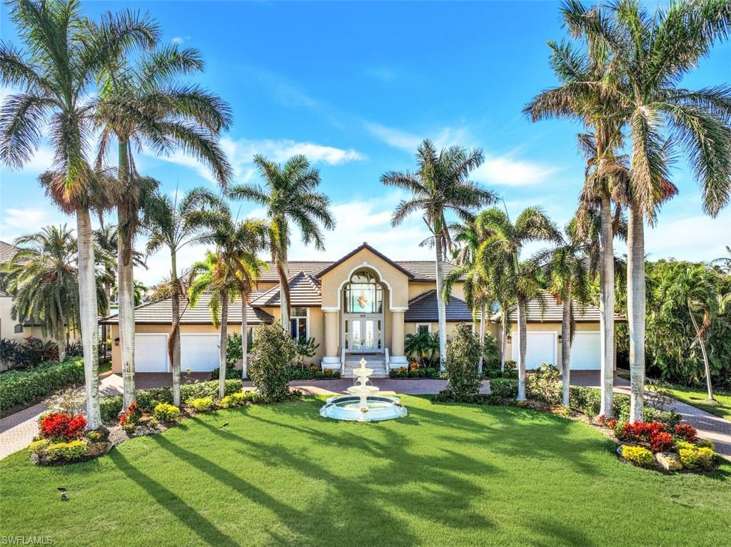 856 Inlet Drive Marco Island, FL 34145 - Photo 2 of 35 a front view of a house with swimming pool garden and swimming pool