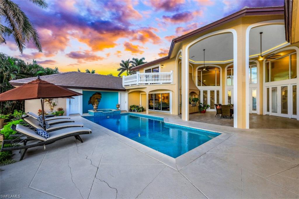 856 Inlet Drive Marco Island, FL 34145 - Photo 26 of 35 a view of a patio with swimming pool table and chairs