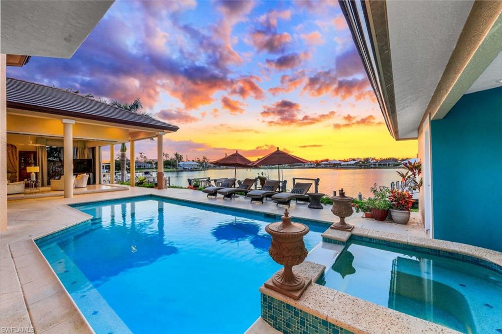 856 Inlet Drive Marco Island, FL 34145 - Photo 3 of 35 a view of a swimming pool with outdoor seating