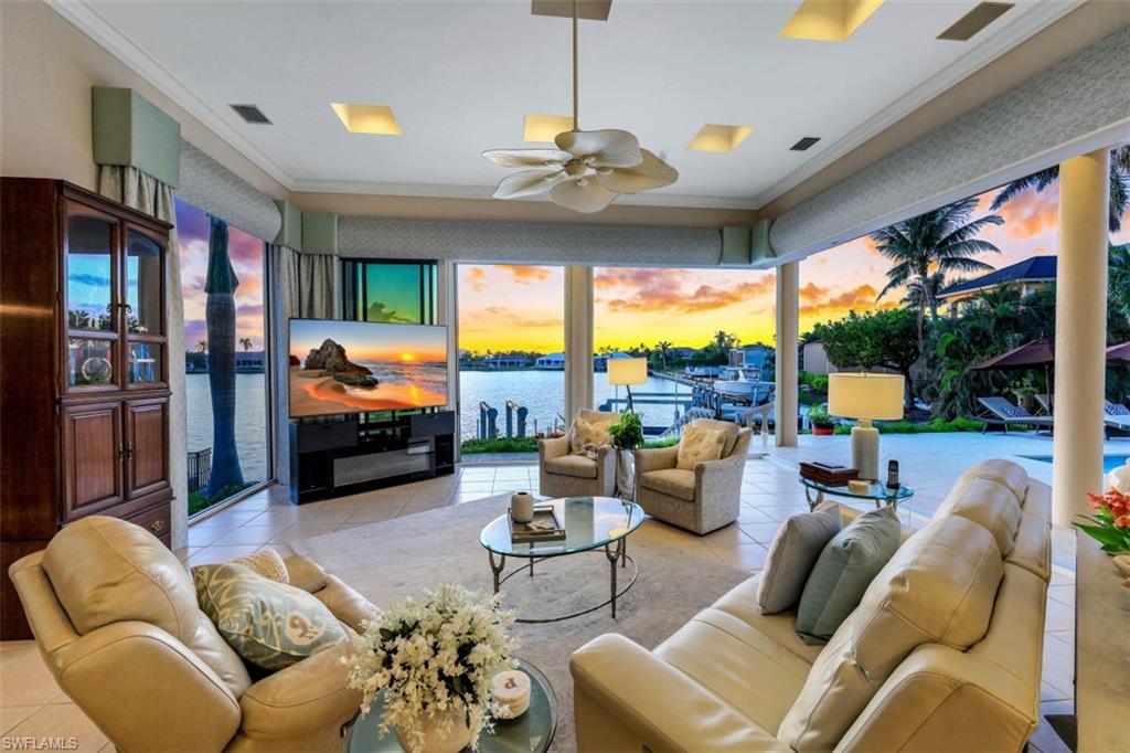 856 Inlet Drive Marco Island, FL 34145 - Photo 4 of 35 a living room with furniture fireplace and floor to ceiling windows