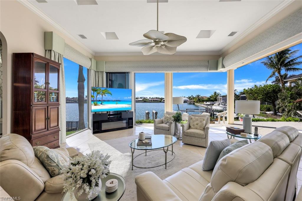 856 Inlet Drive Marco Island, FL 34145 - Photo 6 of 35 a living room with furniture ceiling fan and a rug