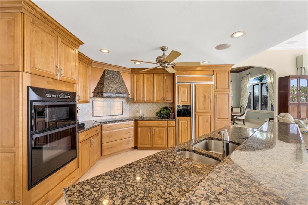 856 Inlet Drive Marco Island, FL 34145 - Photo 7 of 35 a kitchen with a refrigerator and a sink