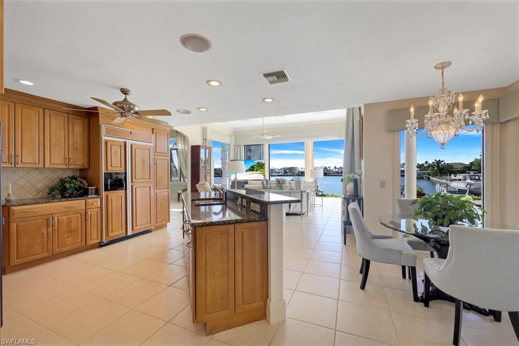 856 Inlet Drive Marco Island, FL 34145 - Photo 8 of 35 a living room with furniture a chandelier and kitchen view