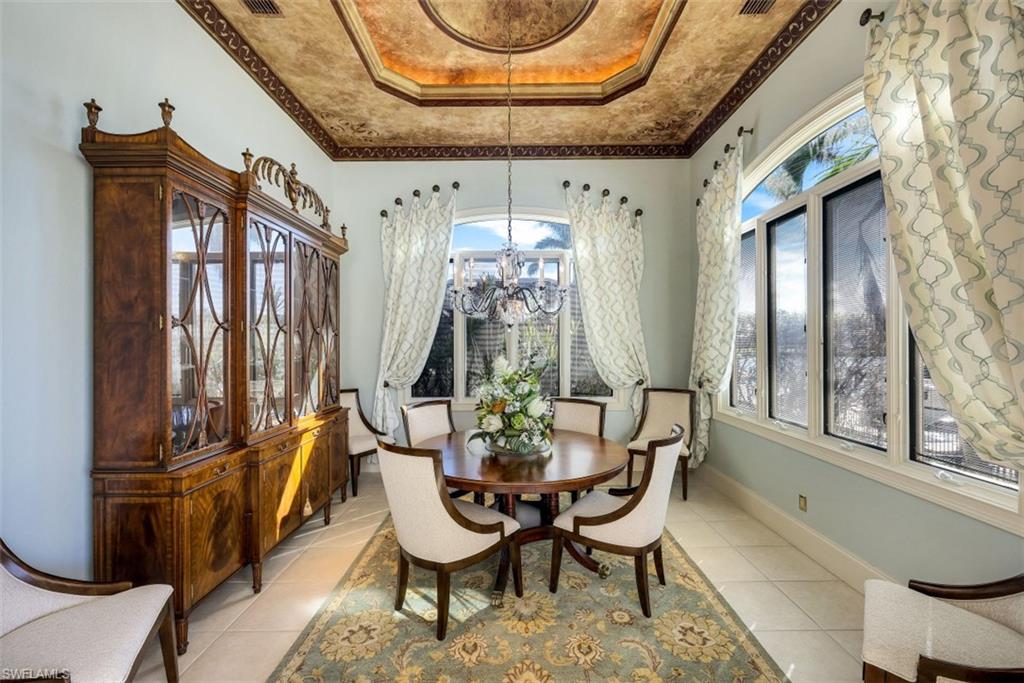 856 Inlet Drive Marco Island, FL 34145 - Photo 10 of 35 a dining room with furniture a chandelier and wooden floor