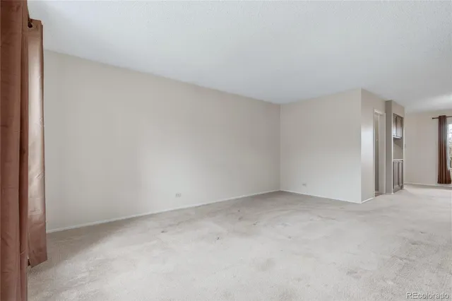 a view of an empty room and closet area