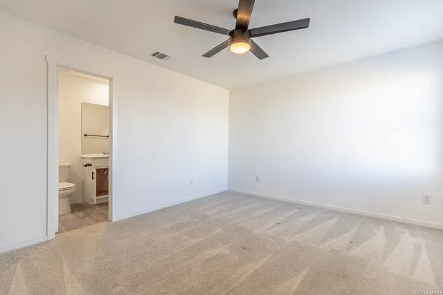 an empty room and a bathroom