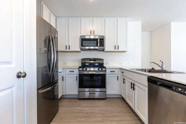a kitchen with a sink and a stove