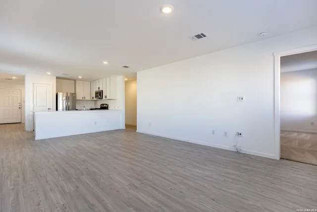 a view of a kitchen with a sink and a refrigerator