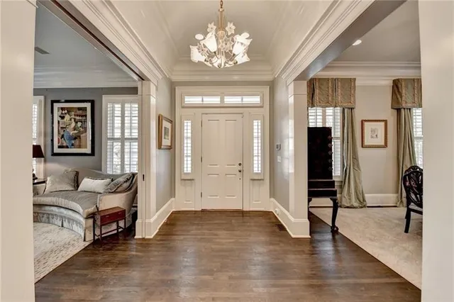 a open kitchen with stainless steel appliances granite countertop a stove oven a refrigerator a couch and a dining table with wooden floor