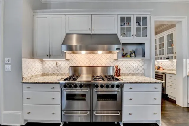 a view of a dining room with furniture a chandelier and a floor to ceiling window