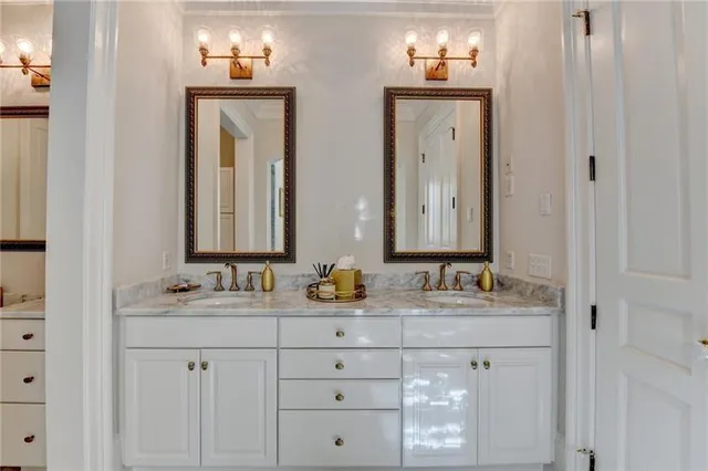 a view of a house with a yard plants and large tree