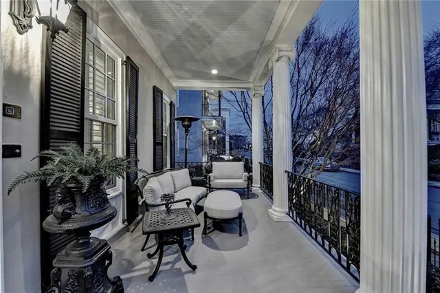 a kitchen with stainless steel appliances granite countertop a dining table chairs stove and refrigerator