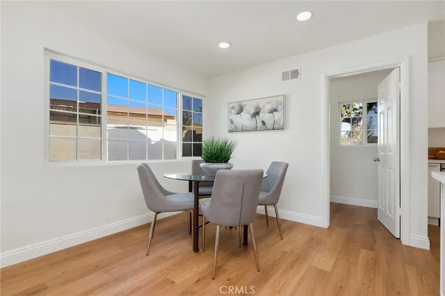 a view of kitchen with furniture and wooden floor