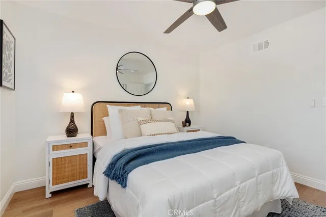 a bedroom with a bed and wooden floor