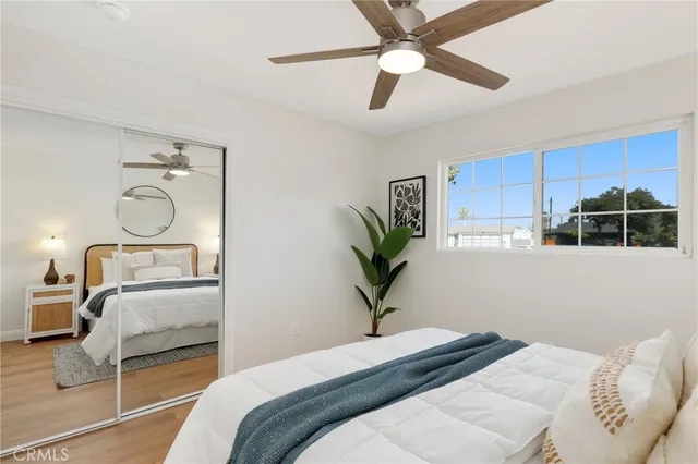 a bed room with a bed and a potted plant