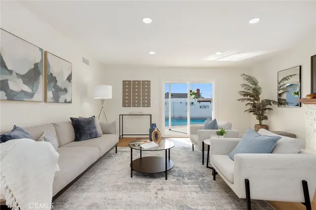 a kitchen with stainless steel appliances wooden floor and chair