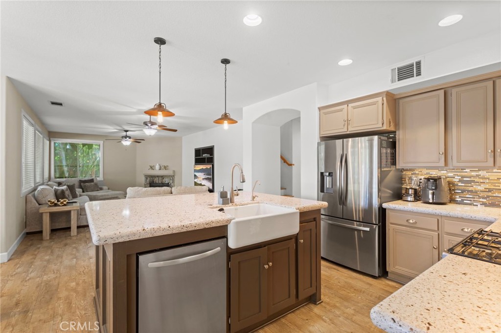 31500 Britton Circle Temecula, CA 92591 - Photo 11 of 44 a kitchen with stainless steel appliances granite countertop a sink a stove a refrigerator and island