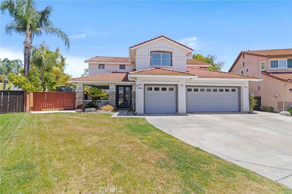 31500 Britton Circle Temecula, CA 92591 - Photo 4 of 44 a front view of a house with a garden