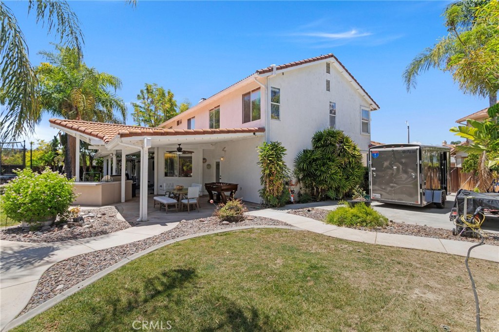 31500 Britton Circle Temecula, CA 92591 - Photo 41 of 44 a view of a patio with table and chairs under an umbrella