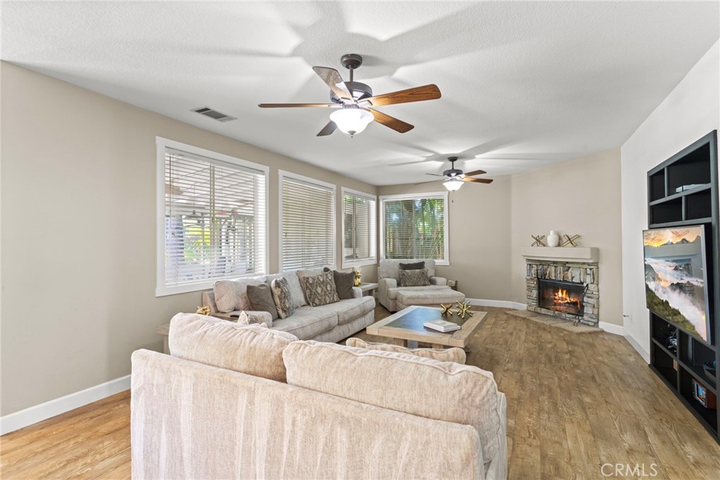 31500 Britton Circle Temecula, CA 92591 - Photo 9 of 44 a living room with furniture a fireplace and a flat screen tv