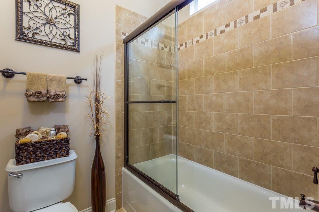 1908 Falls Farm Crossing Raleigh, NC 27614 - Photo 10 of 25 a bathroom with a bathtub and shower