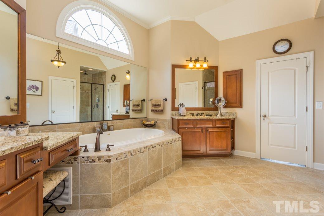 1908 Falls Farm Crossing Raleigh, NC 27614 - Photo 14 of 25 a bathroom with a tub sink and mirror