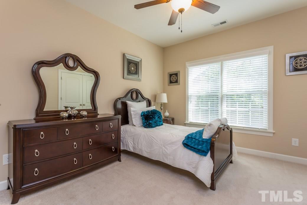 1908 Falls Farm Crossing Raleigh, NC 27614 - Photo 19 of 25 a bedroom with a bed and a chandelier