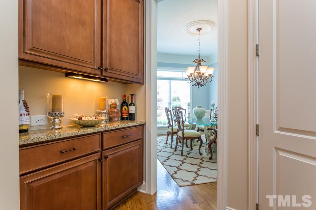 1908 Falls Farm Crossing Raleigh, NC 27614 - Photo 6 of 25 a hallway with dining table and chandelier