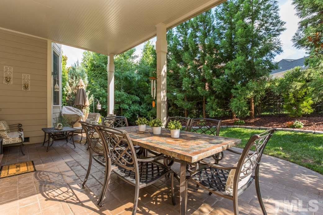 1908 Falls Farm Crossing Raleigh, NC 27614 - Photo 7 of 25 a view of patio with table and chairs and floor to ceiling window