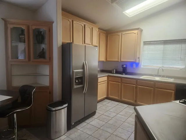 a kitchen with stainless steel appliances a refrigerator sink and cabinets