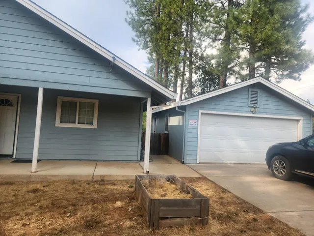a front view of a house with garage