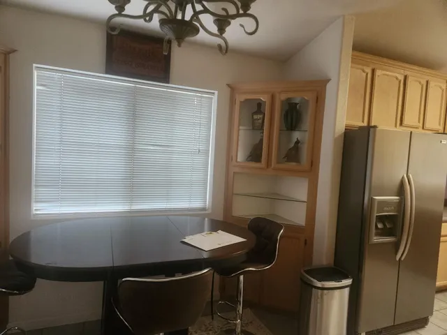 a kitchen with stainless steel appliances a refrigerator and a table