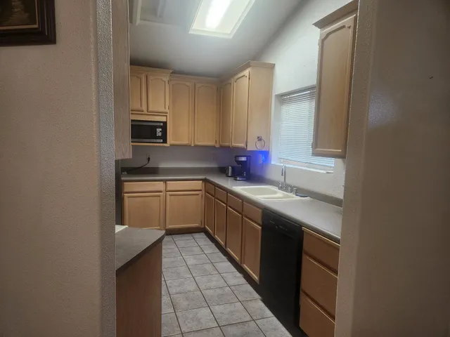 a kitchen with a sink cabinets and appliances