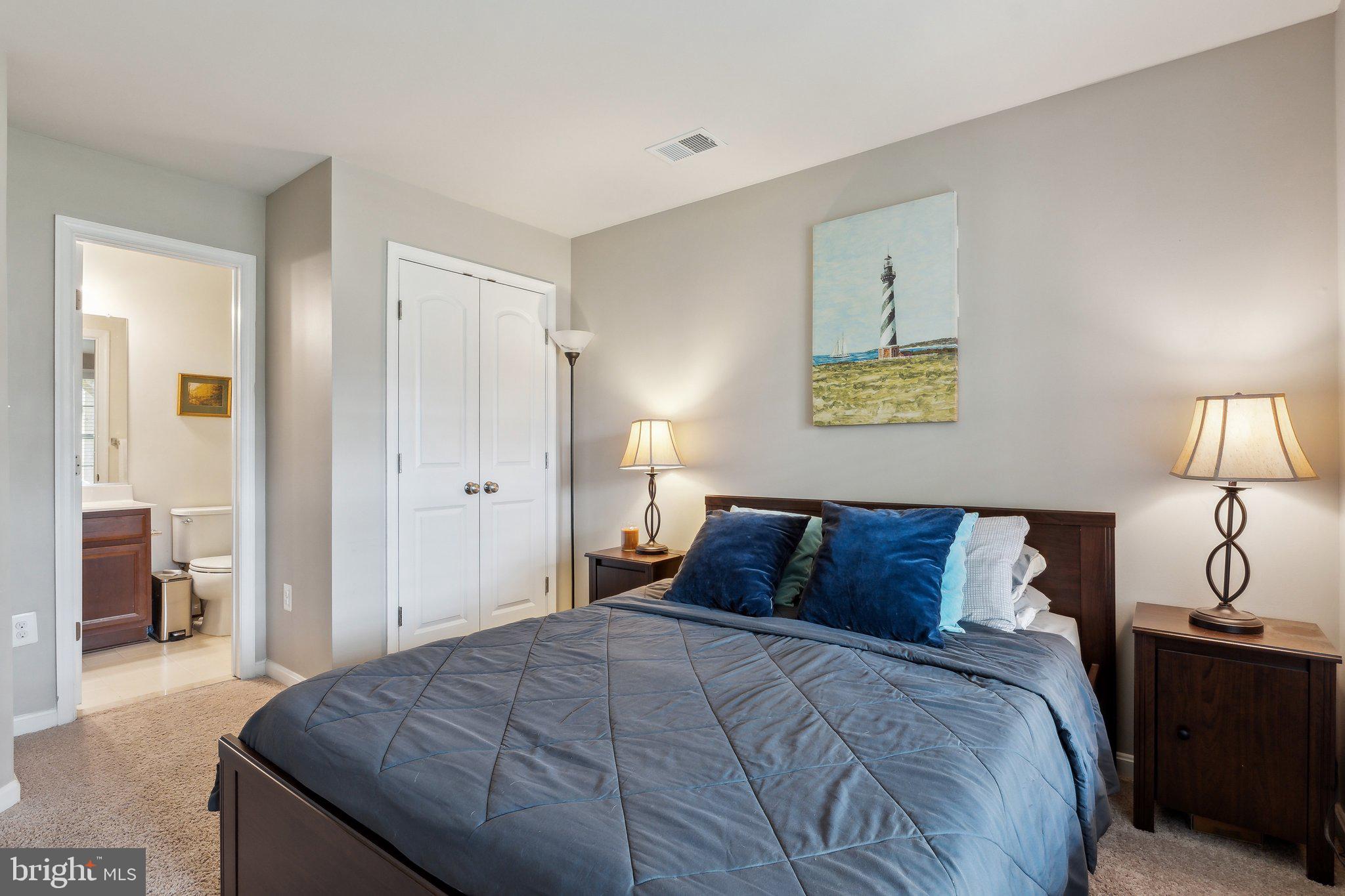 305 Hersden Lane Arnold, MD 21012 - Photo 15 of 23 a bedroom with a bed and a lamp