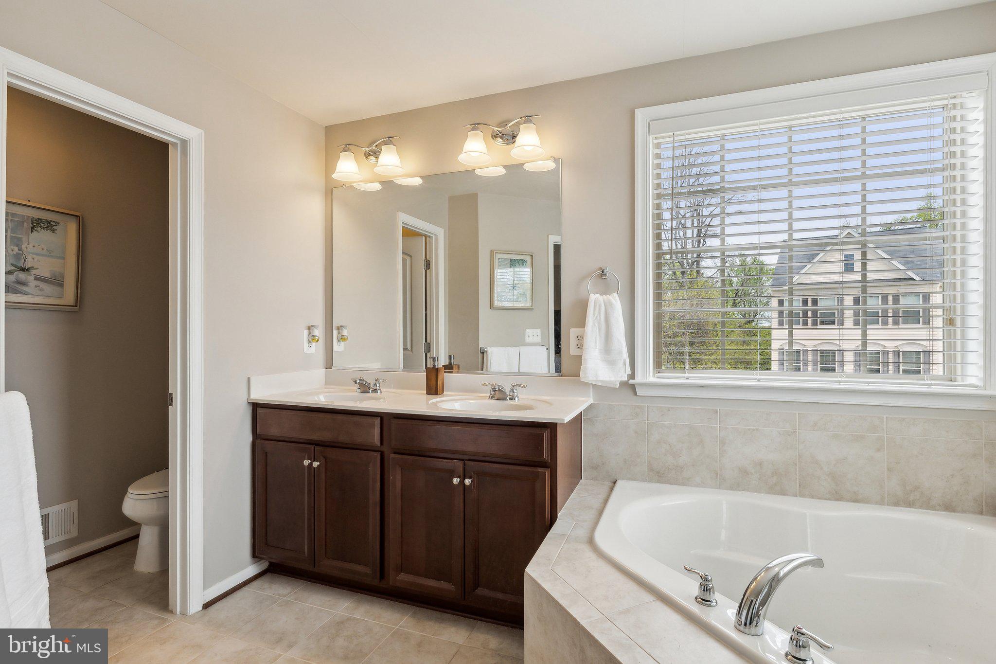 305 Hersden Lane Arnold, MD 21012 - Photo 19 of 23 a bathroom with a tub sink and mirror