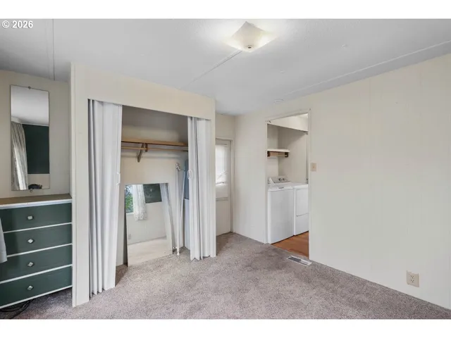 a big room with closet and mirror