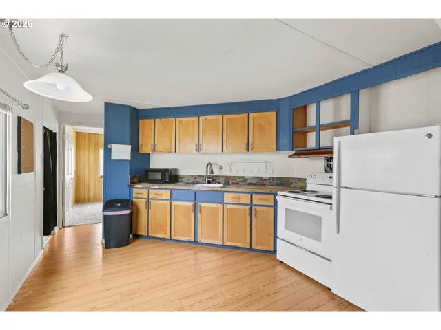 a kitchen with stainless steel appliances granite countertop a refrigerator sink and stove