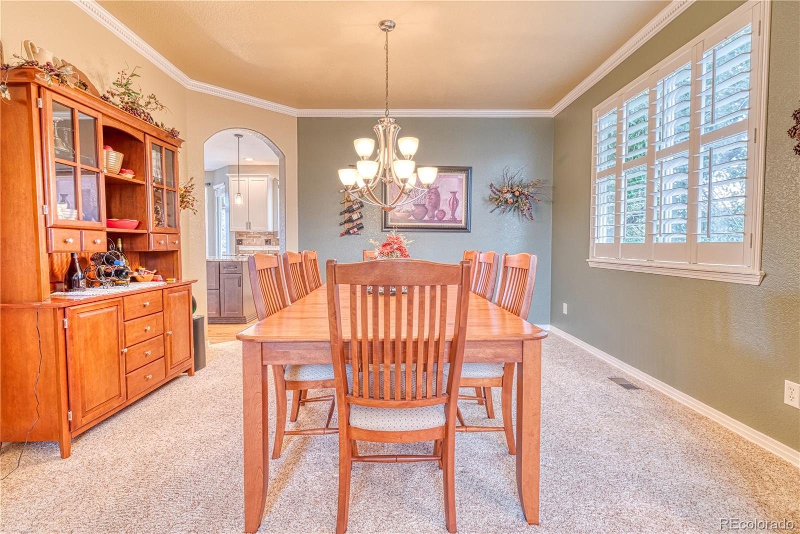 6378 Umber Circle Arvada, CO 80403 - Photo 18 of 50 a dining room with furniture a chandelier and window