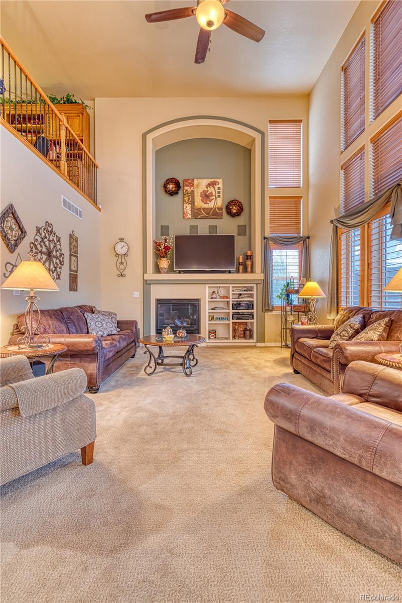 6378 Umber Circle Arvada, CO 80403 - Photo 29 of 50 a living room with furniture and a fireplace