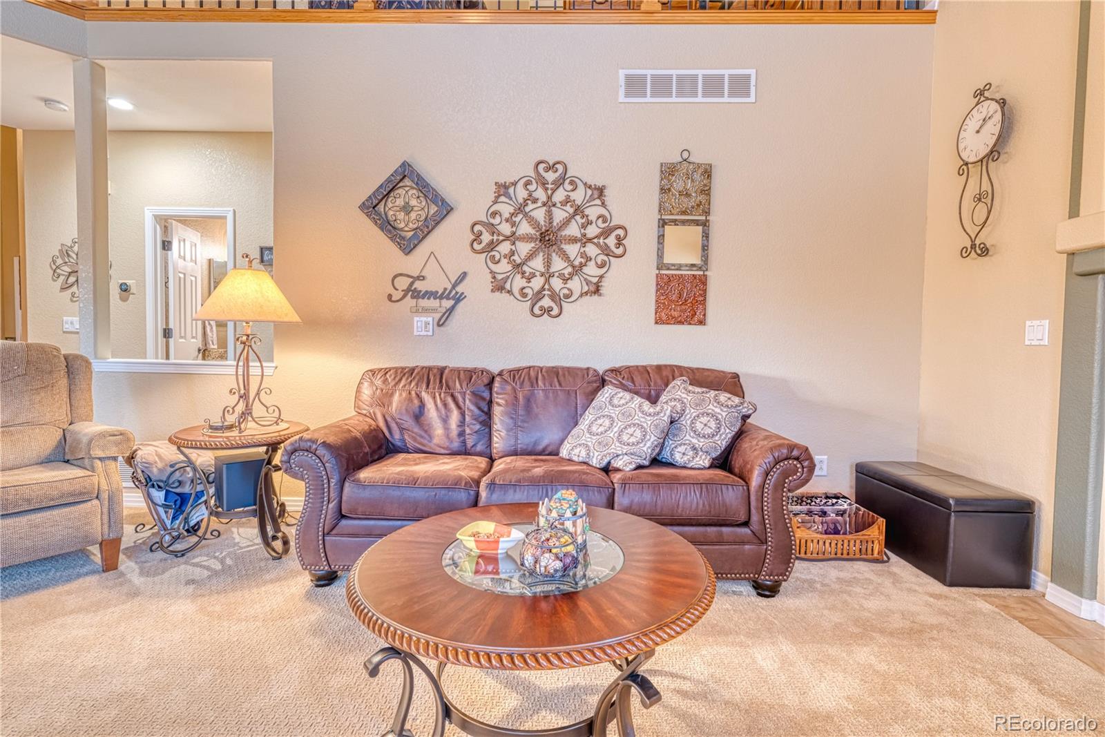 6378 Umber Circle Arvada, CO 80403 - Photo 30 of 50 a living room with furniture and a lamp