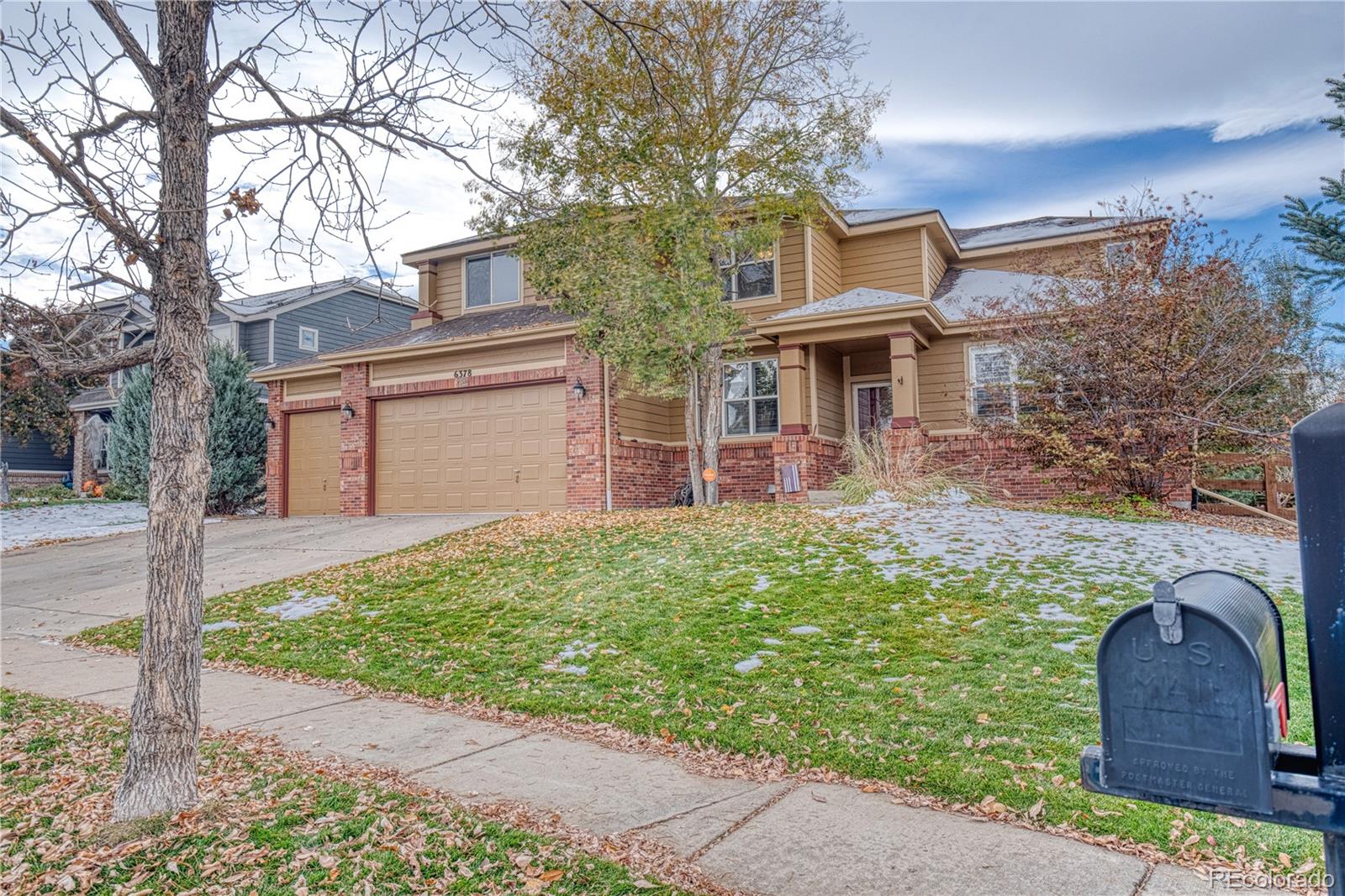 6378 Umber Circle Arvada, CO 80403 - Photo 3 of 50 a front view of a house with garden