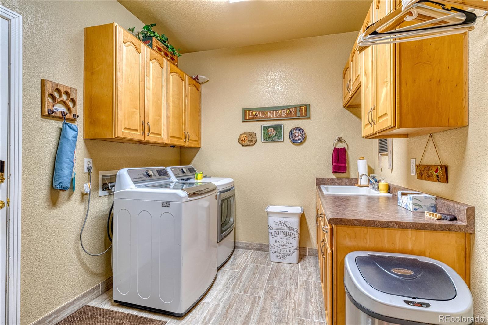 6378 Umber Circle Arvada, CO 80403 - Photo 33 of 50 a utility room with a sink washer and dryer