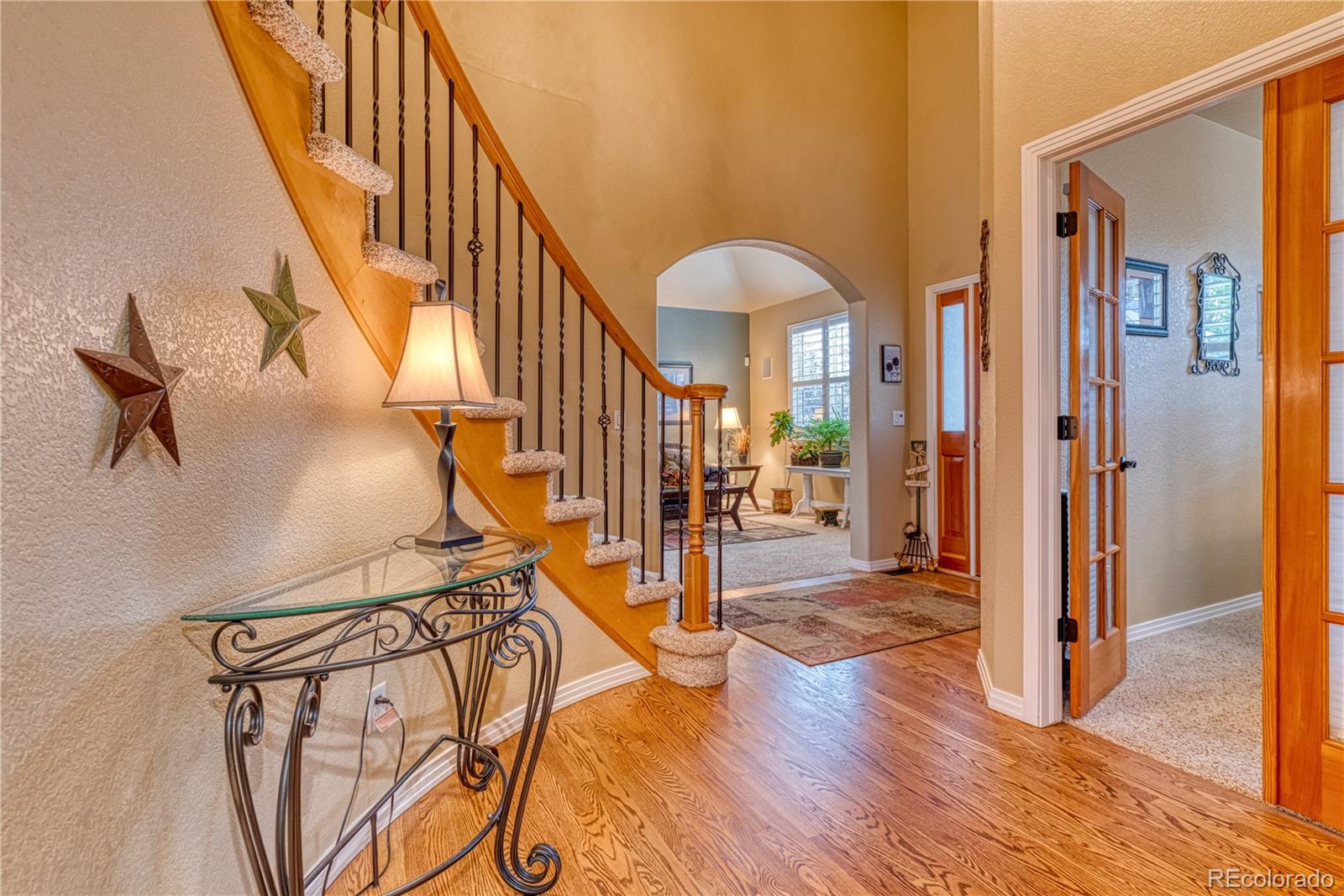 6378 Umber Circle Arvada, CO 80403 - Photo 41 of 50 a view of an entryway with wooden floor and a livingroom view