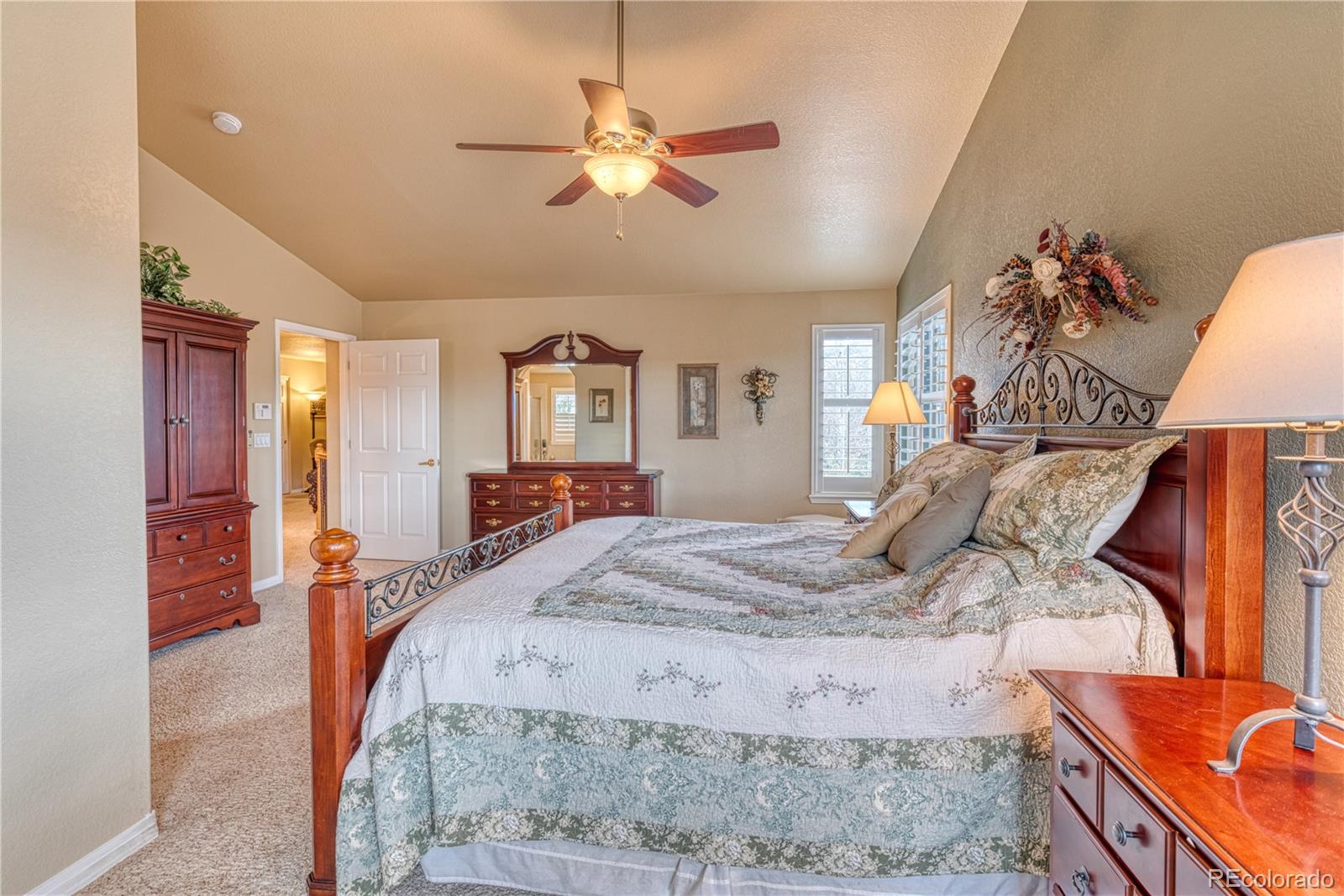 6378 Umber Circle Arvada, CO 80403 - Photo 46 of 50 a bed room with a bed and a chandelier