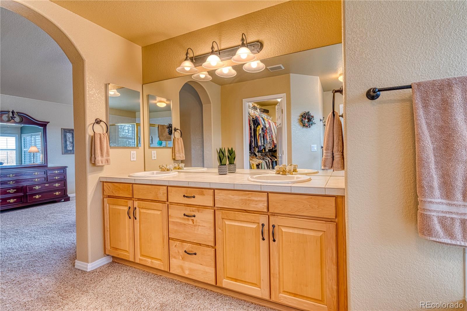 6378 Umber Circle Arvada, CO 80403 - Photo 48 of 50 a bathroom with a double vanity sink and a mirror