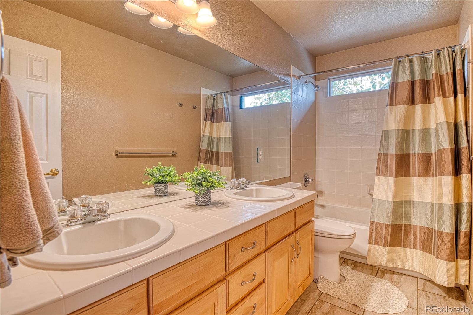 6378 Umber Circle Arvada, CO 80403 - Photo 49 of 50 a bathroom with a sink a double vanity and a mirror