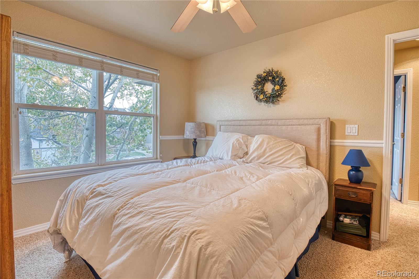 6378 Umber Circle Arvada, CO 80403 - Photo 50 of 50 a bedroom with a bed and a large window
