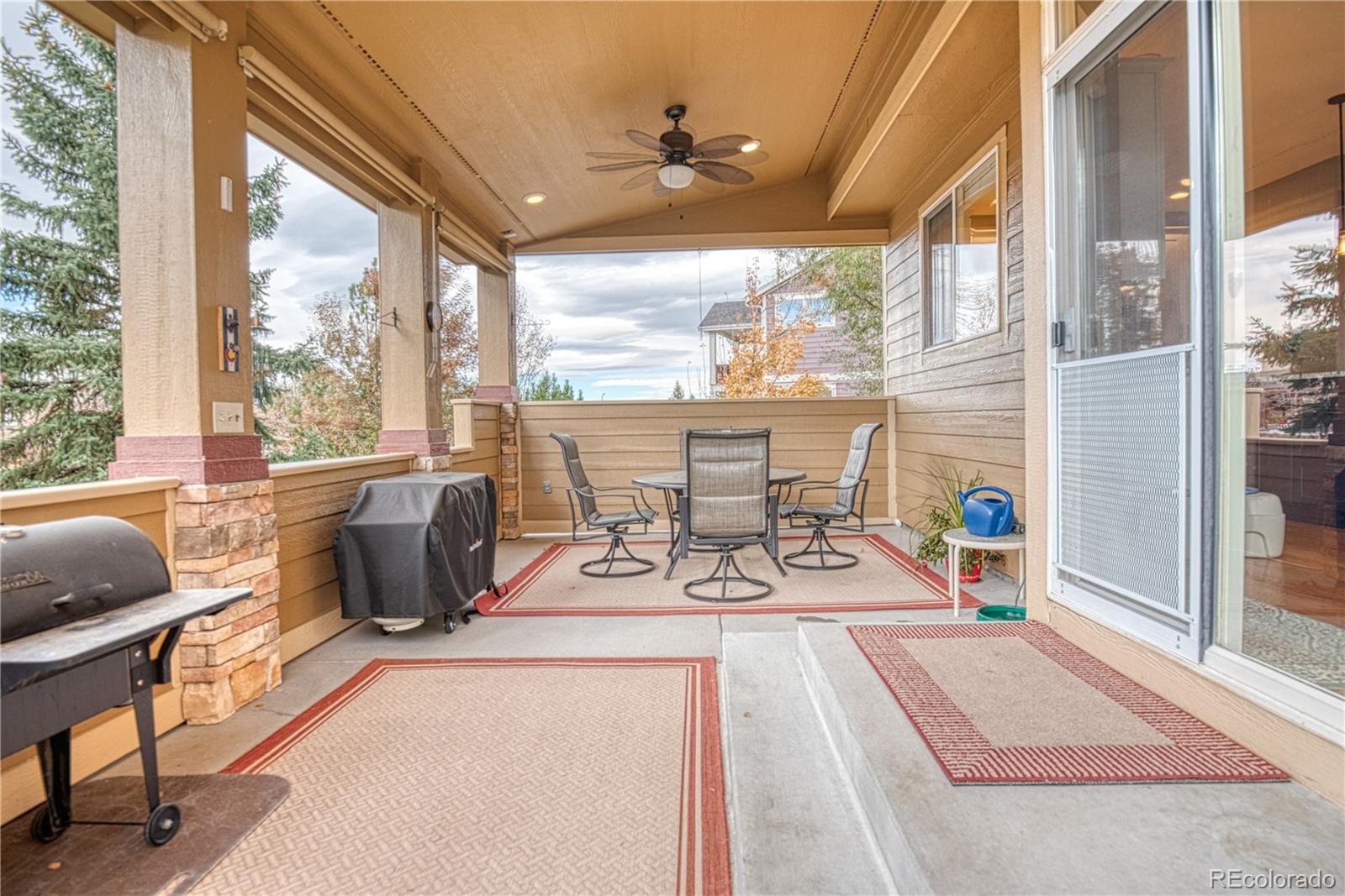 6378 Umber Circle Arvada, CO 80403 - Photo 6 of 50 a view of a living room with furniture and floor to ceiling windows
