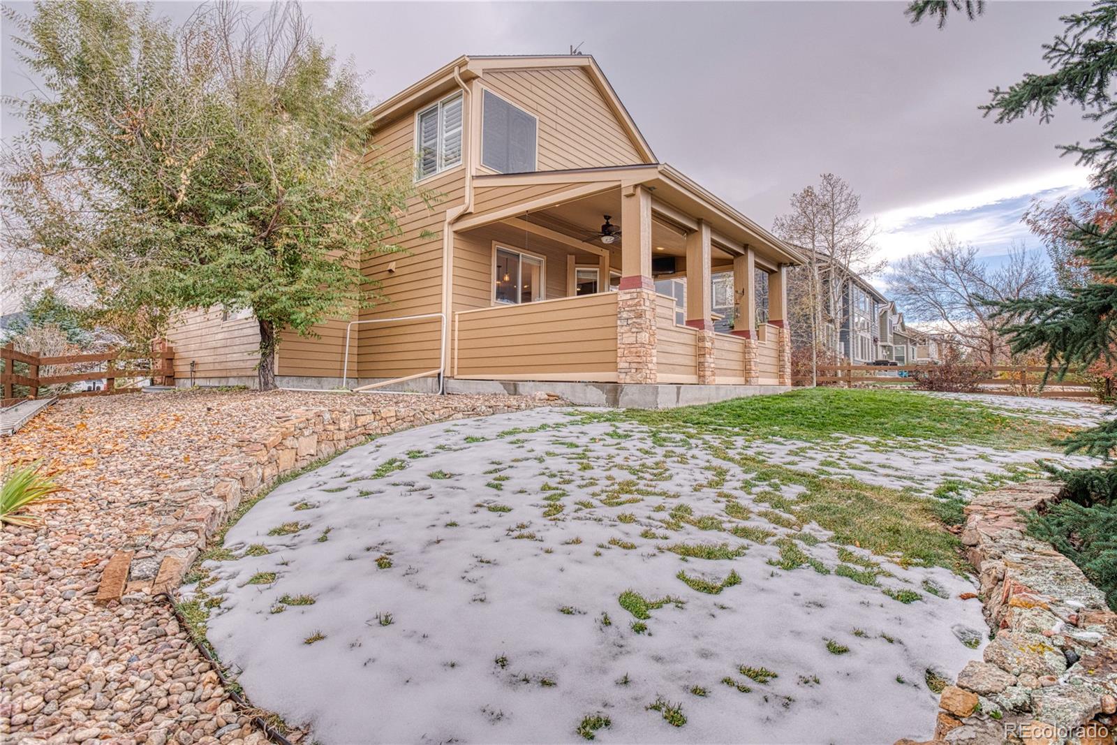 6378 Umber Circle Arvada, CO 80403 - Photo 8 of 50 a front view of a house with a yard